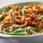 45 degree close shot of vegetarian green bean casserole with creamy mushroom sauce and crispy onions